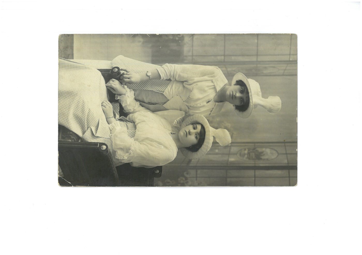 Two women in WWI-era military-inspired outfits and feathered studio hats, C. Barash studio, Bucharest